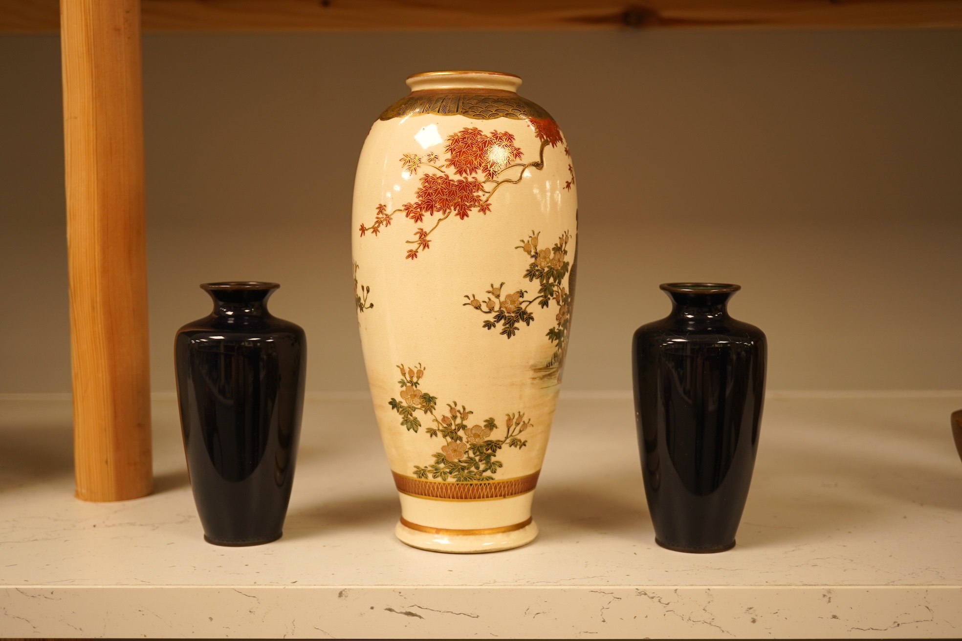 A Japanese figural satsuma vase and a pair of small black cloisonné enamel vases, Satsuma 21.5cm high